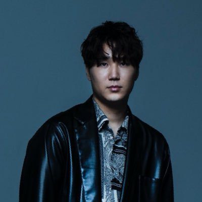The one who played a bass and wearing black jacket.